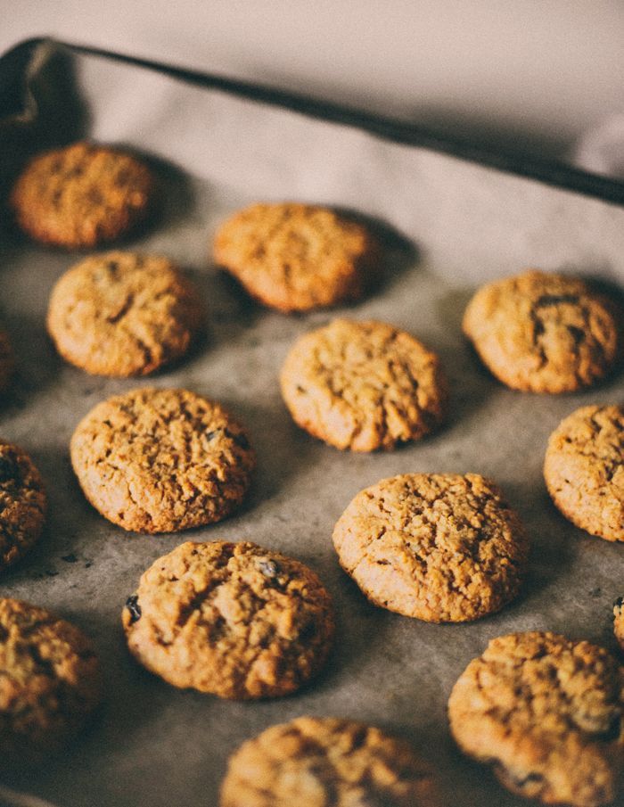 Oatmeal cookies fresh out of the oven arranged on a baking tray. Perfect snack or dessert.