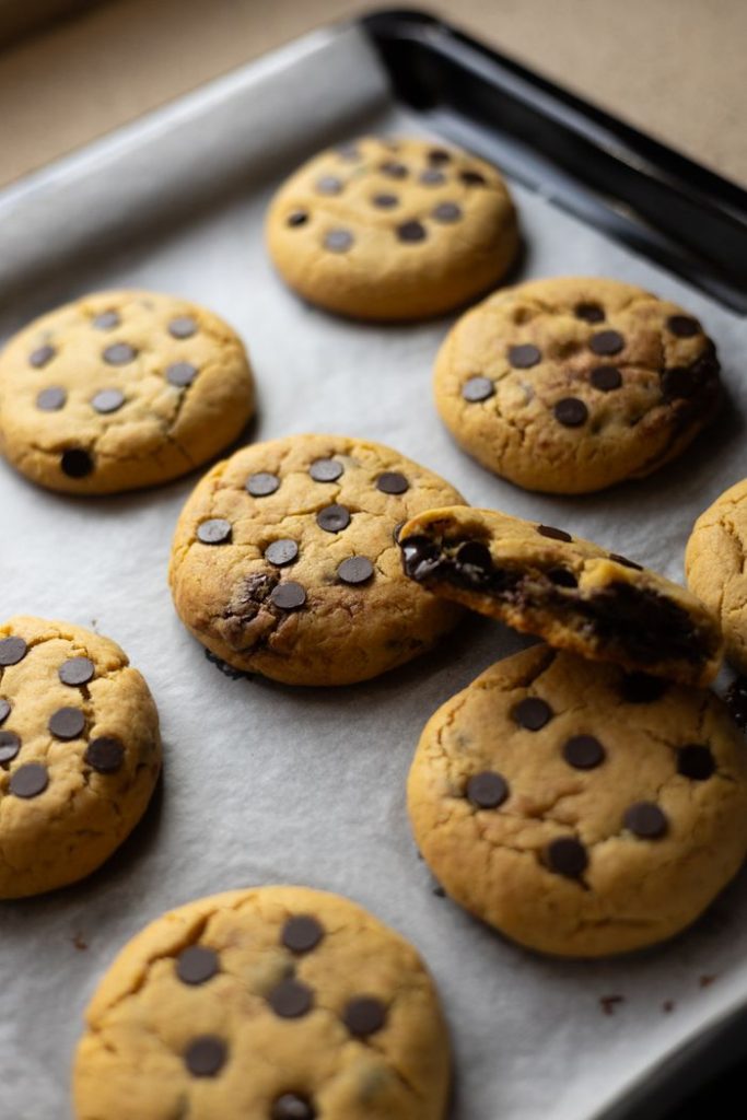 Delicious chocolate chip cookies fresh out of the oven on a baking tray.